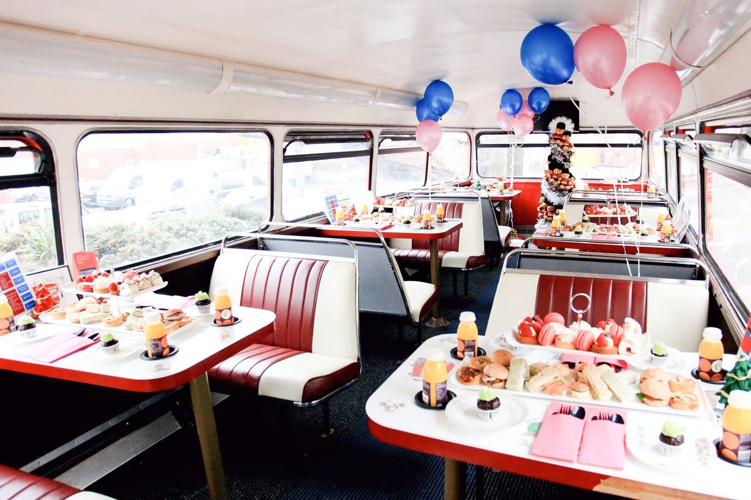 The interior of the vintage double decker tour bus for the BB Bakery Afternoon Tea Bus Tour in London.