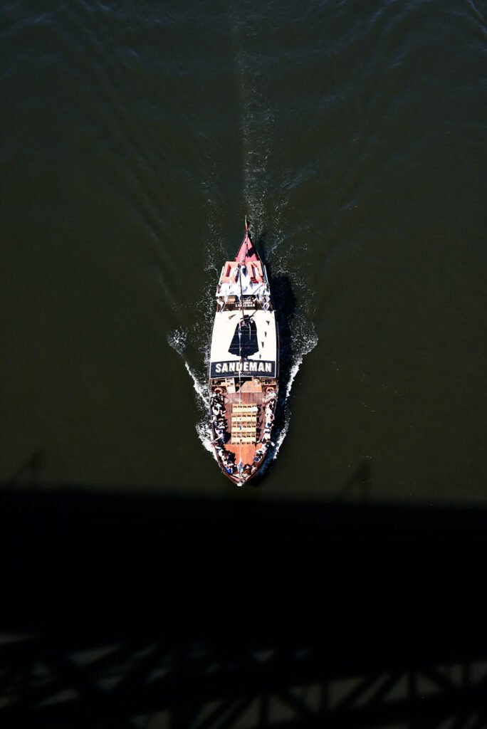 Weekend in Porto - 6 Experiences you don't want to miss. Boat under the Dom Luis I Bridge