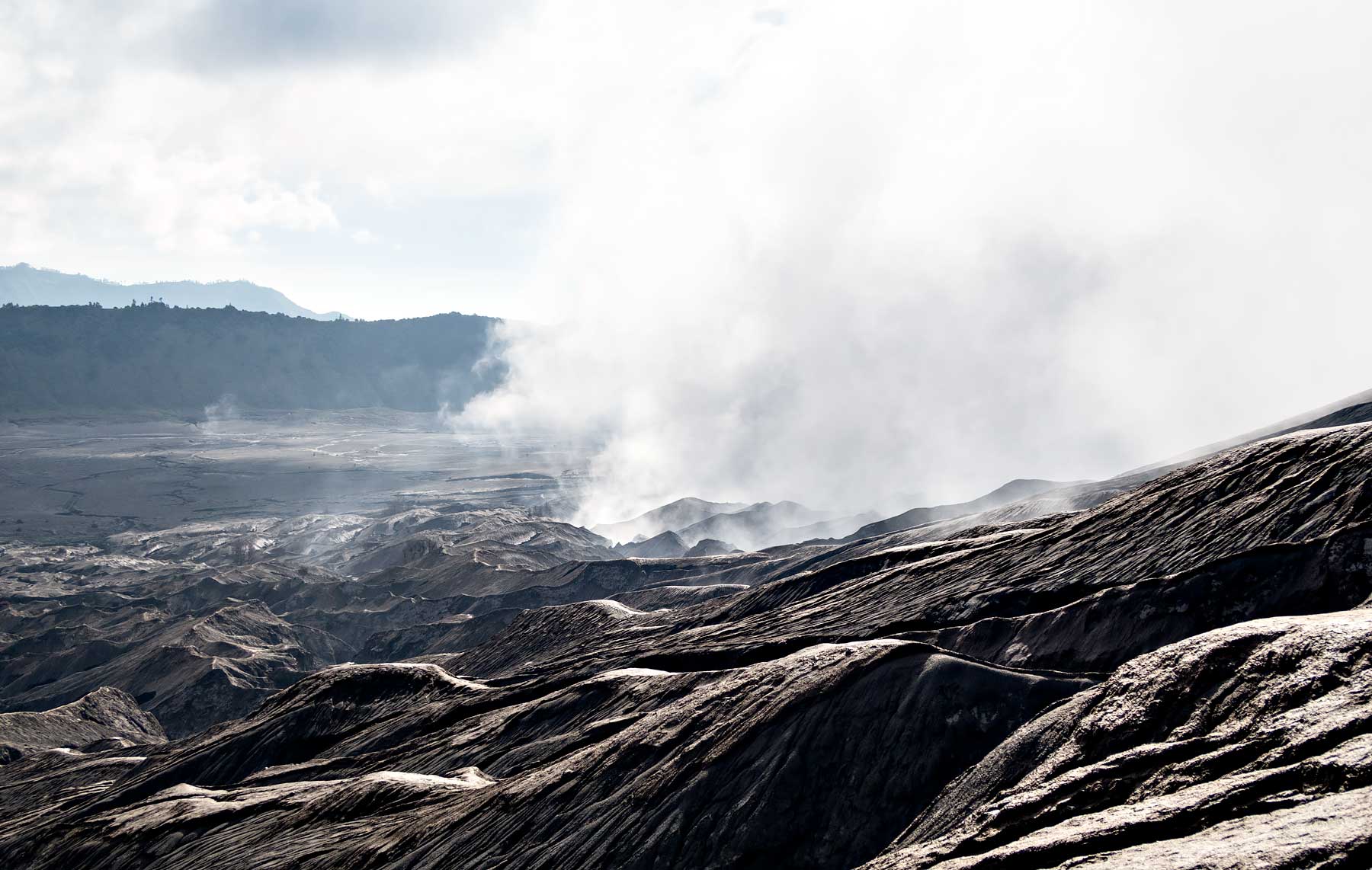 Steam coming from Mount Bromo, Indonesia. Read the review of my Mount Bromo Tour: Climbing an active volcano in East Java, Indonesia on Urban Pixxels.