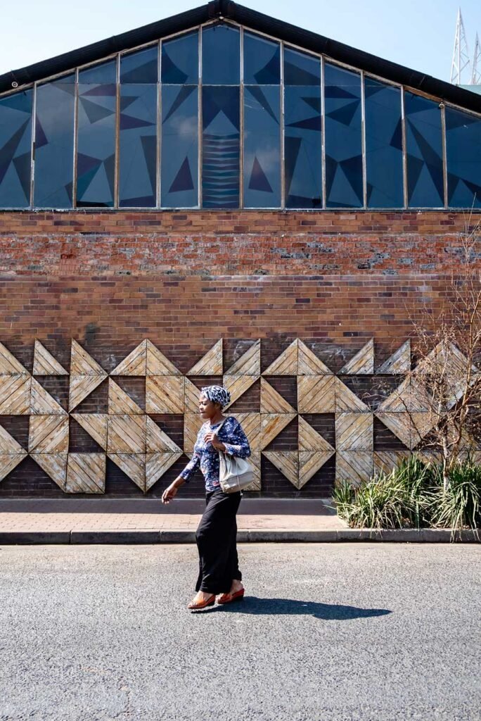 Woman crossing the street in Maboneng, Johannesburg. South Africa in 3 Weeks | The Perfect South Africa itinerary for your first trip.
