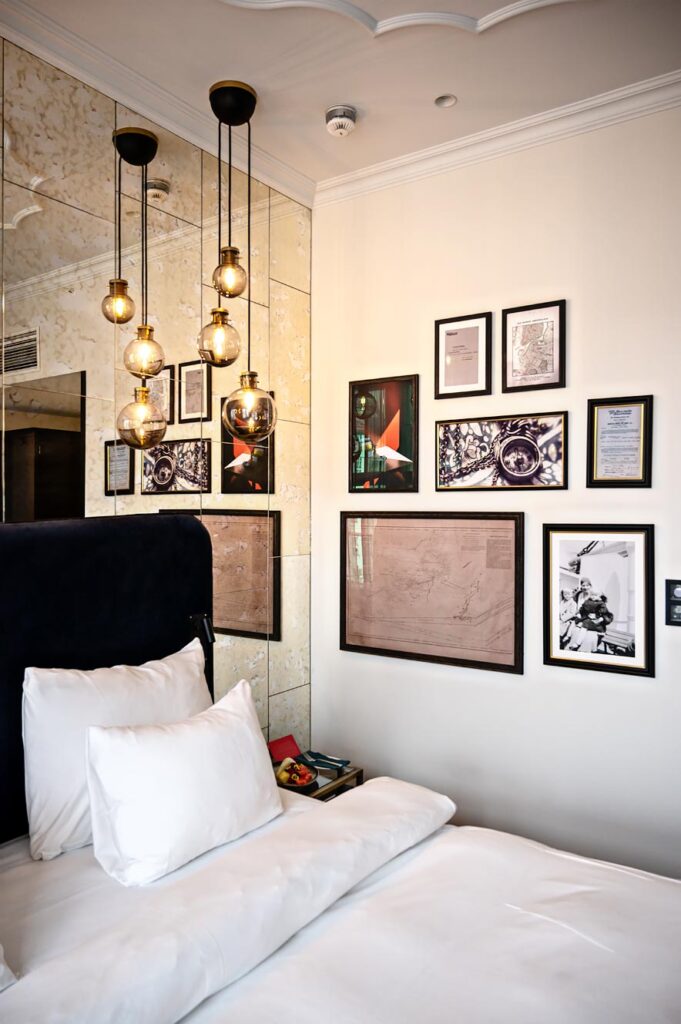 Hotel room at Amerikalinje, Oslo's new boutique hotel with vintage photos and maps on the wall.