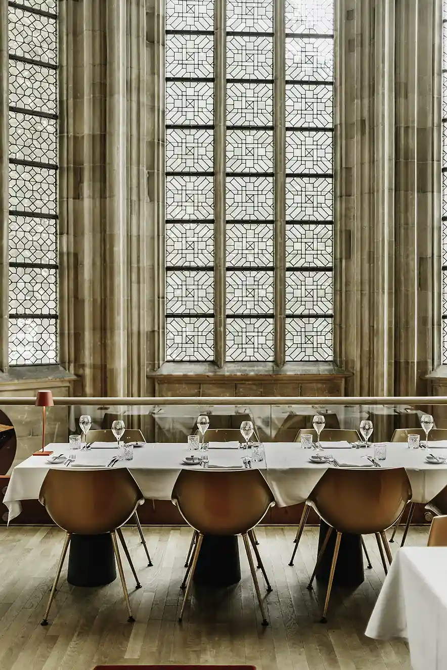 Lekker eten in het Kruisherenhotel Maastricht. Tafel bij Spencer's restaurant met wit linnen binnen in de gotische kerk