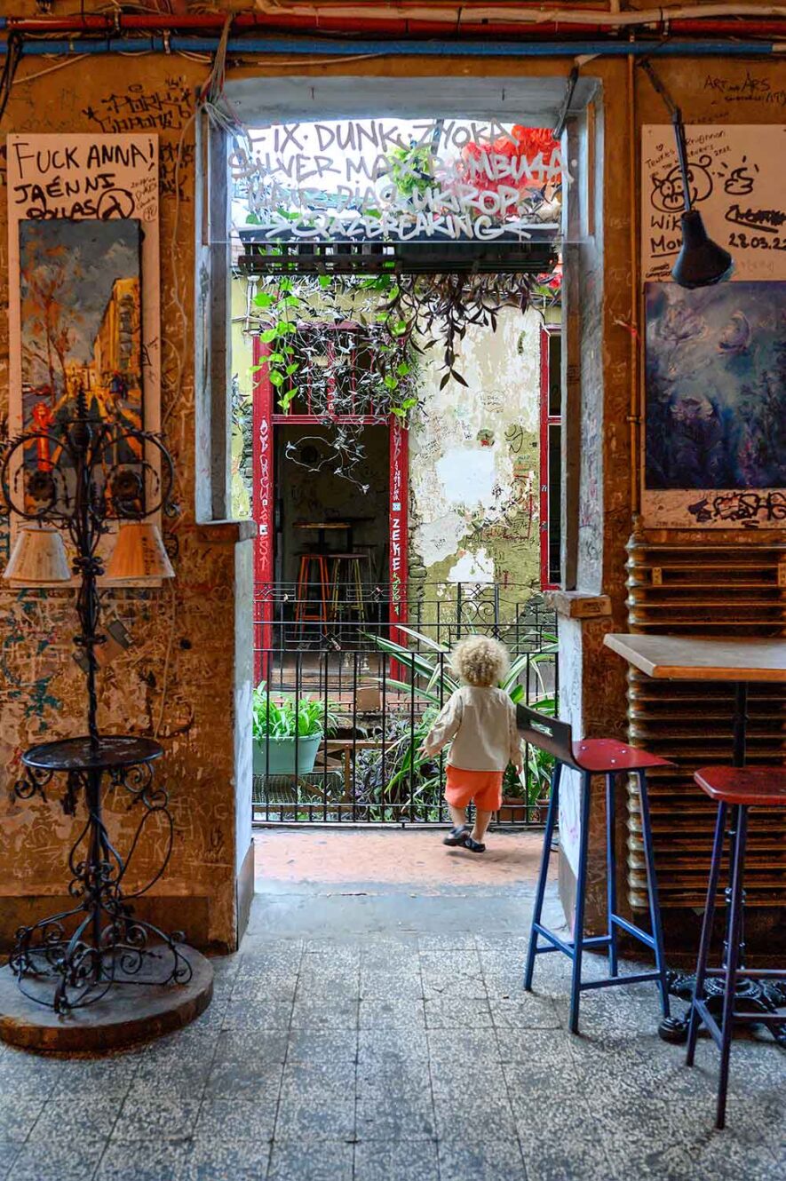 Kind loopt rond in Szimpla Kert, een van de leukste dingen om te doen als je voor het eerst in Boedapest bent.
