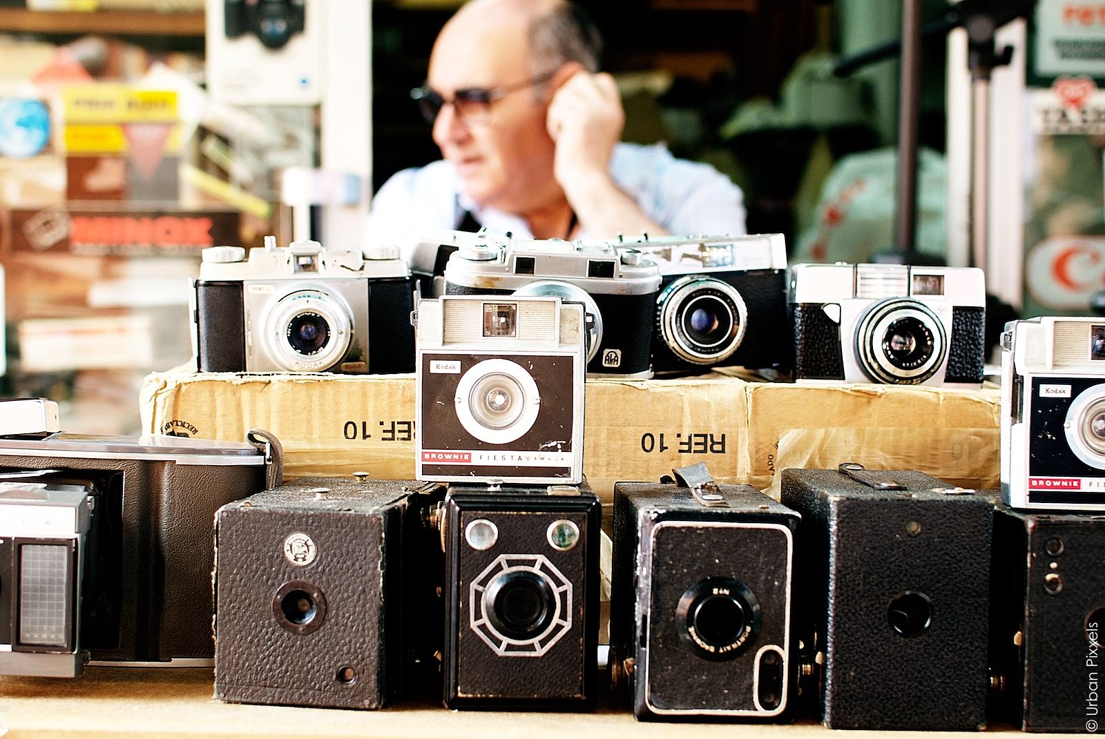 Spanish men selling vintage cameras on the el Rastro market in Madrid